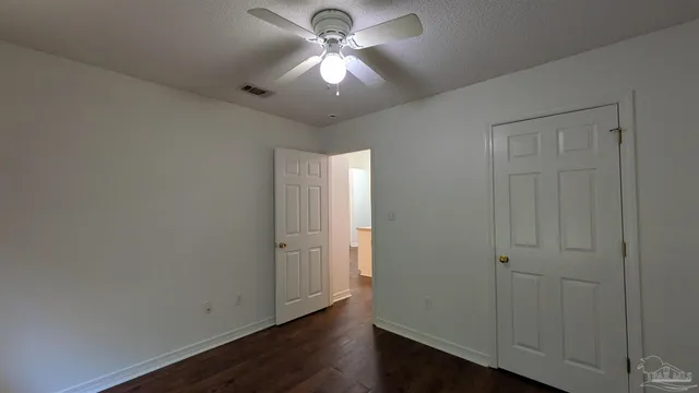 a bathroom with a toilet and a mirror
