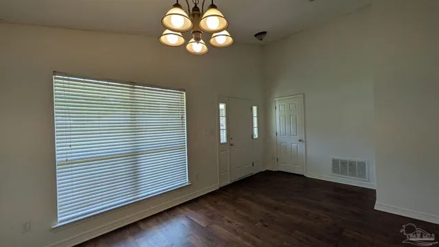 a kitchen with a sink cabinets and wooden floor