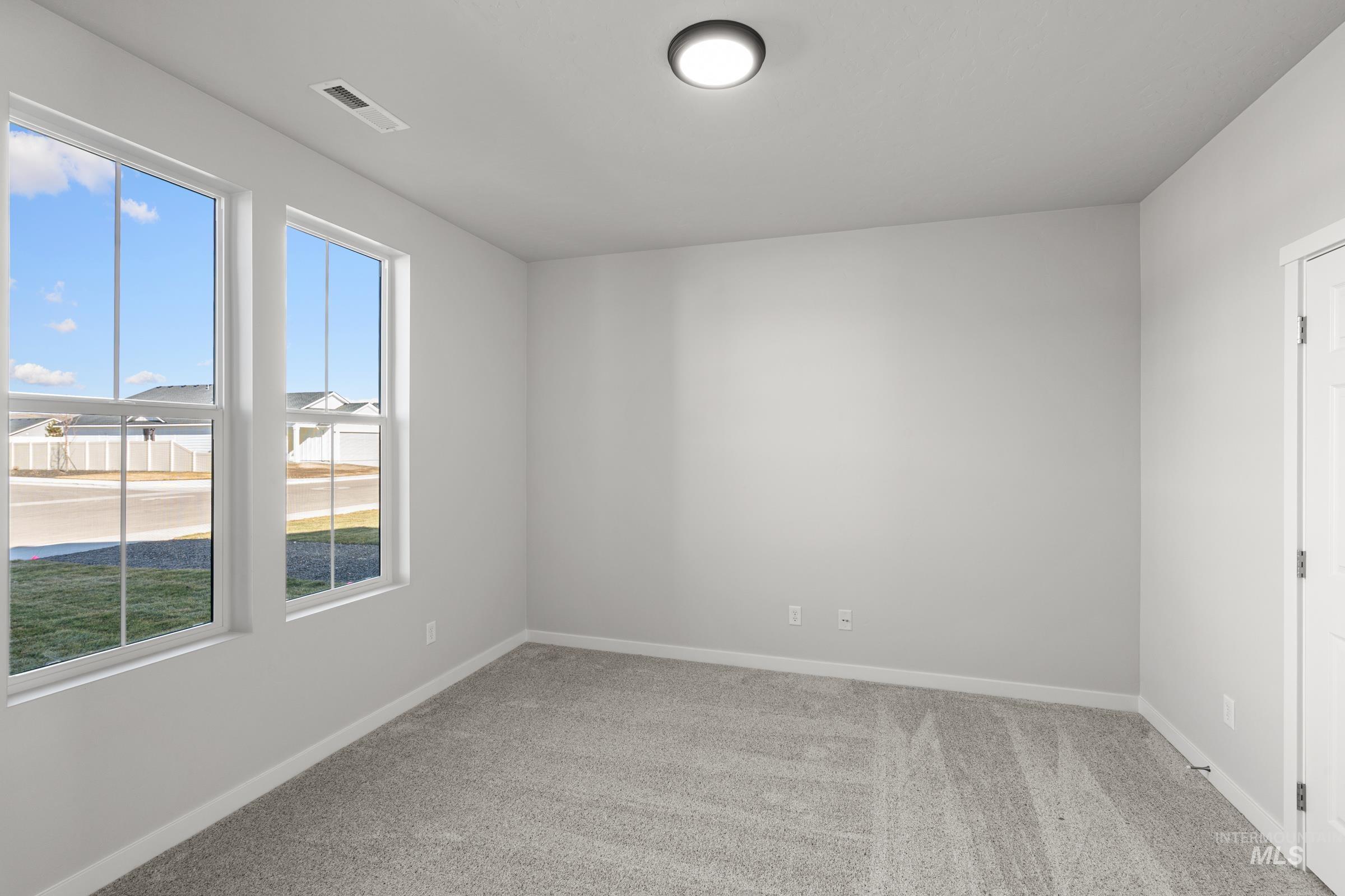 1641 Dyer Street Middleton, ID 83644 - Photo 11 of 28 Unfurnished room featuring light colored carpet and baseboards