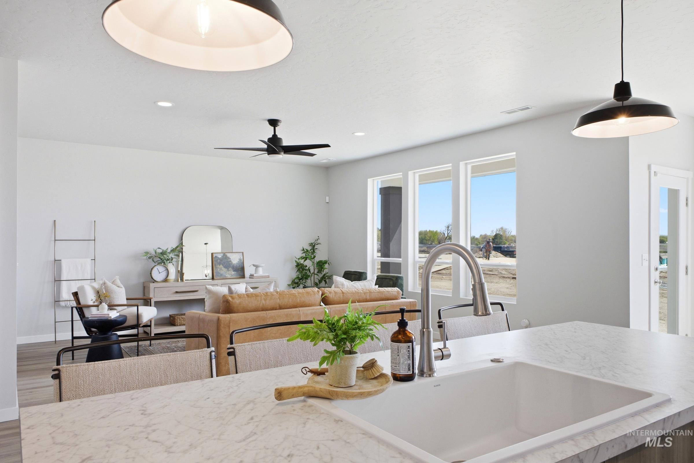 1641 Dyer Street Middleton, ID 83644 - Photo 29 of 29 Kitchen with light countertops, open floor plan, wood finished floors, hanging light fixtures, and a ceiling fan