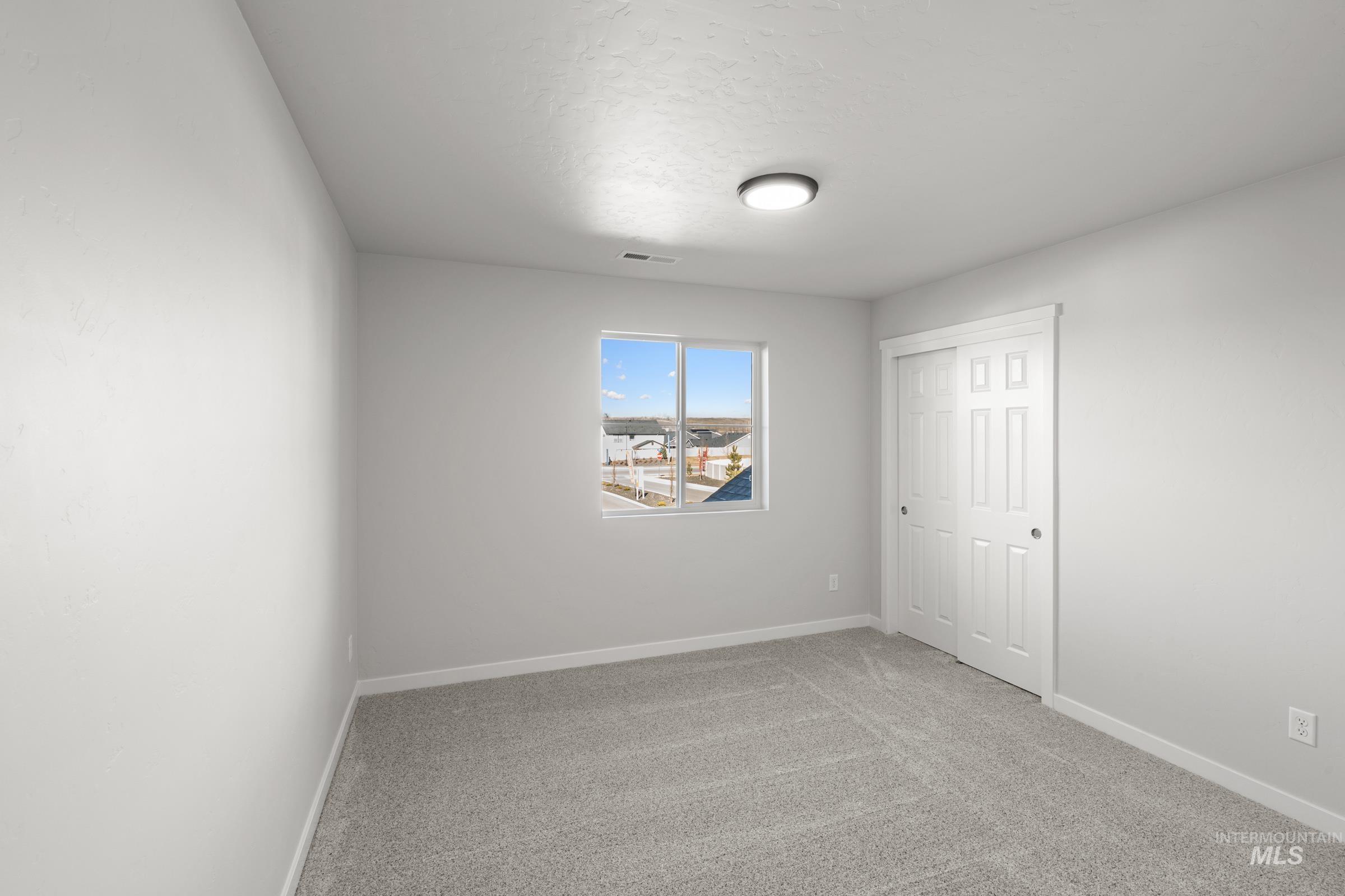 1641 Dyer Street Middleton, ID 83644 - Photo 16 of 28 Unfurnished bedroom featuring light carpet and a closet