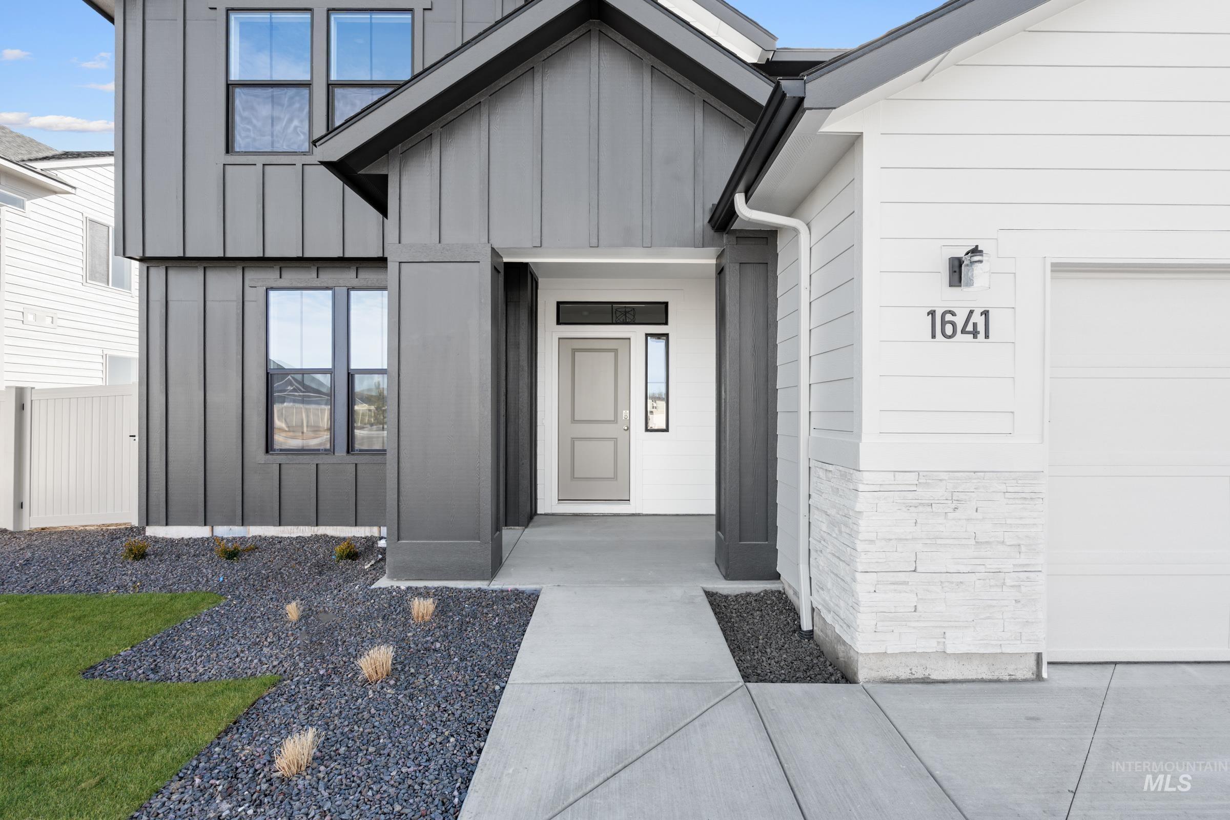 1641 Dyer Street Middleton, ID 83644 - Photo 2 of 28 View of exterior entry featuring board and batten siding and a garage