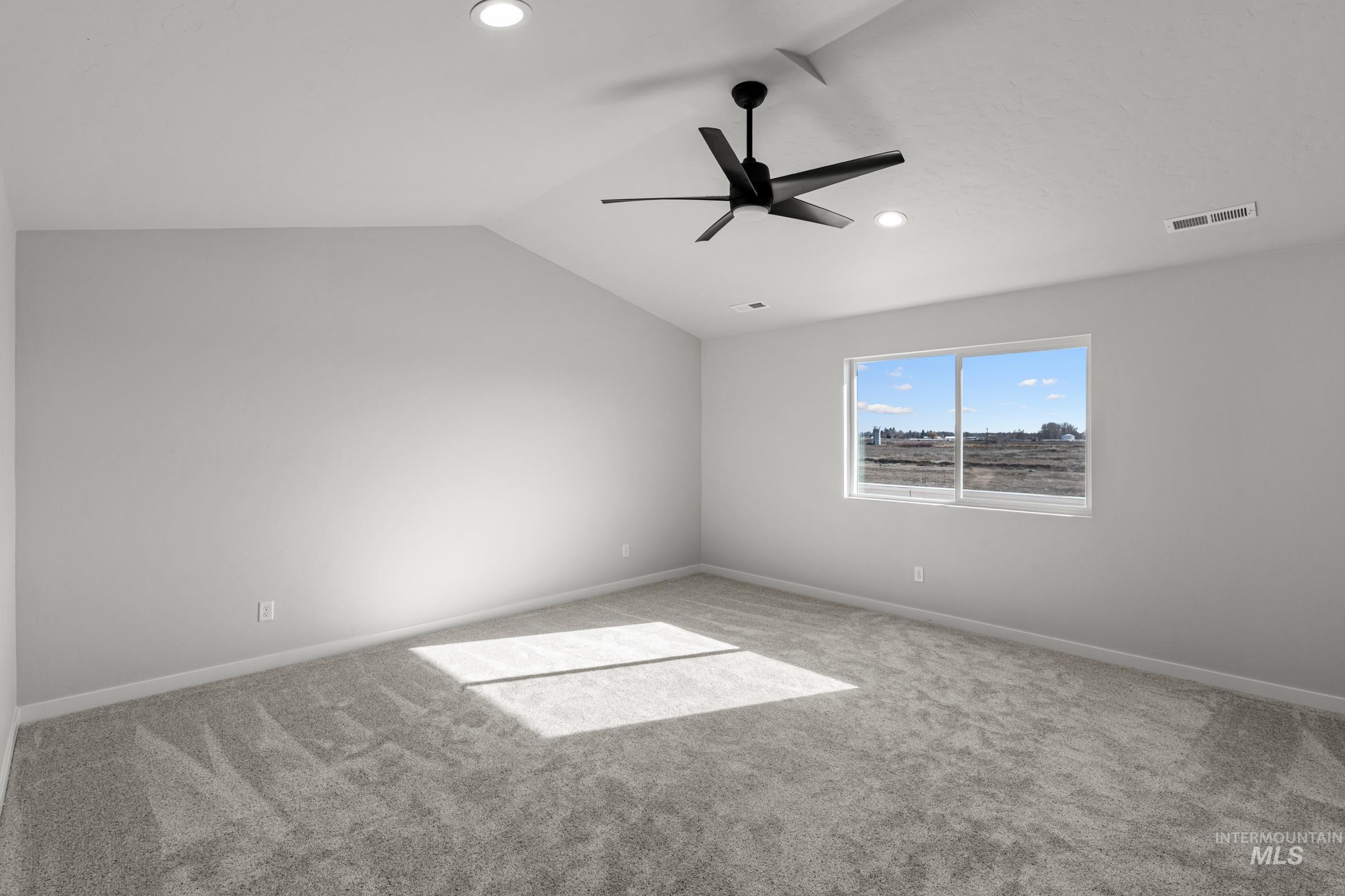 1641 Dyer Street Middleton, ID 83644 - Photo 20 of 28 Empty room with carpet floors, vaulted ceiling, ceiling fan, and recessed lighting