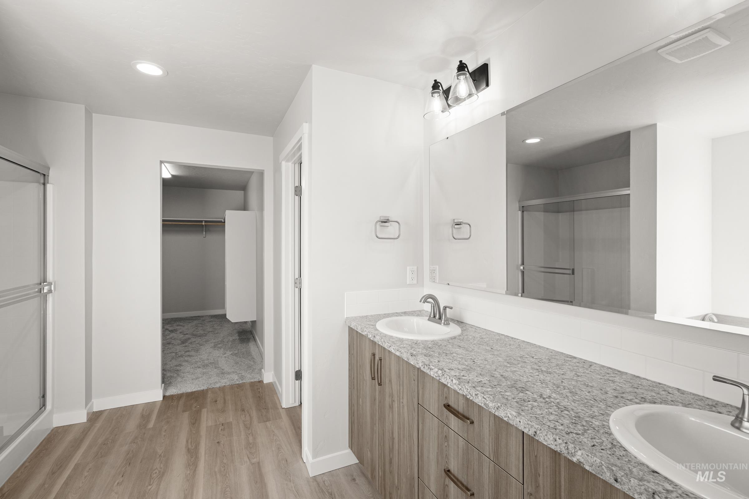 1641 Dyer Street Middleton, ID 83644 - Photo 25 of 28 Full bathroom featuring a shower stall, double vanity, light wood-style flooring, a walk in closet, and recessed lighting
