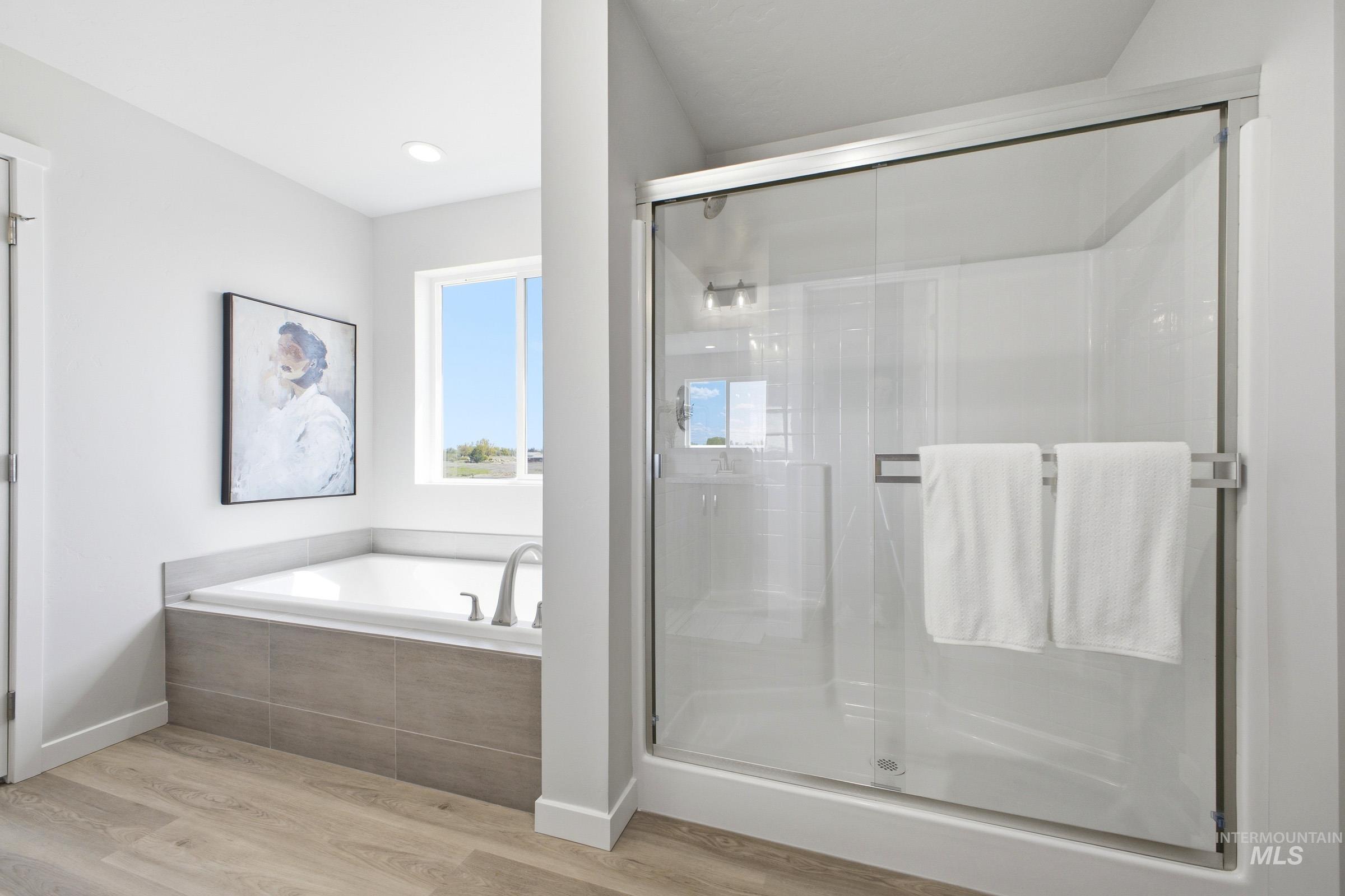 1641 Dyer Street Middleton, ID 83644 - Photo 28 of 29 Bathroom featuring light wood finished floors, a stall shower, and a bath