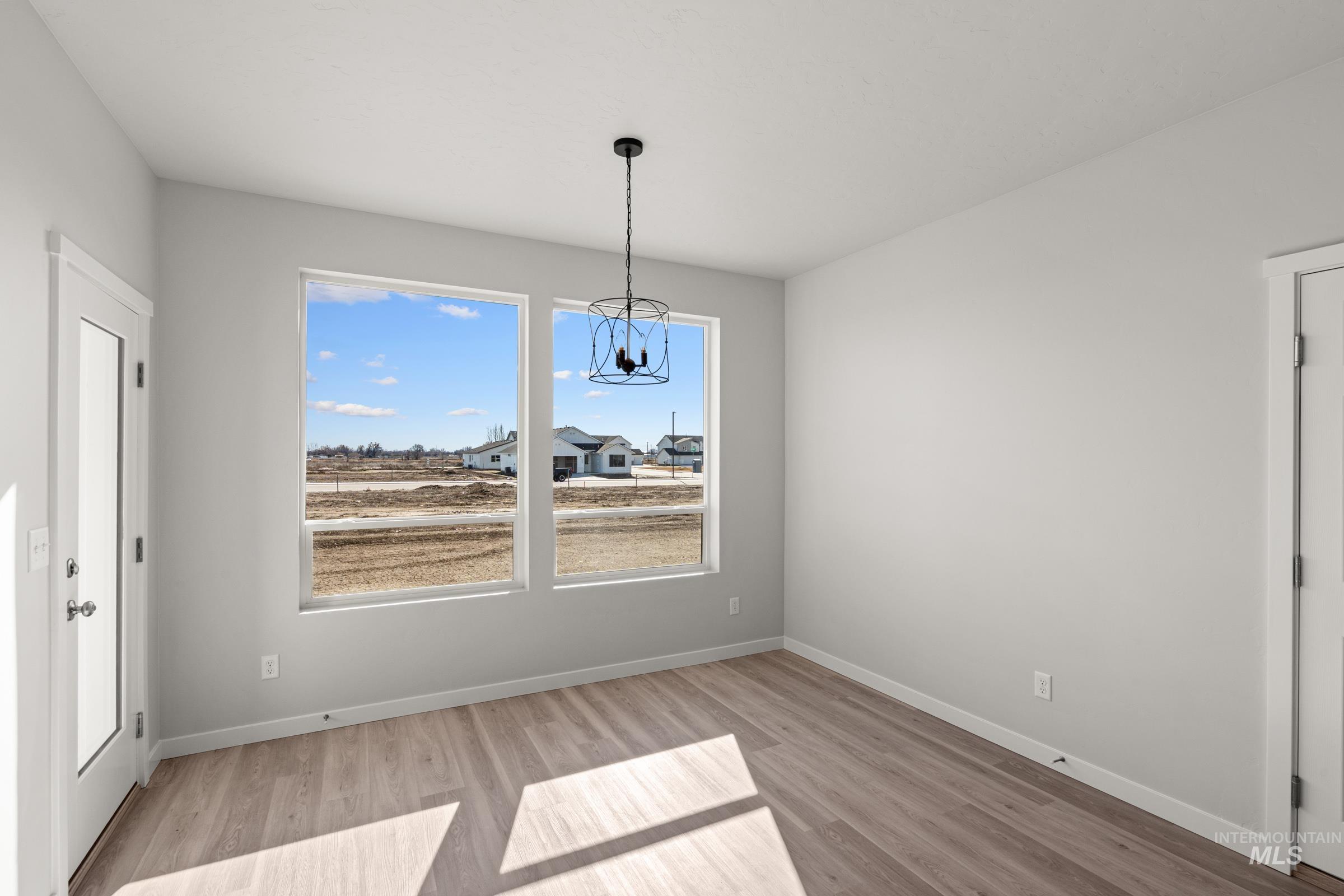 1641 Dyer Street Middleton, ID 83644 - Photo 7 of 28 Unfurnished dining area with light wood finished floors and hanging lights