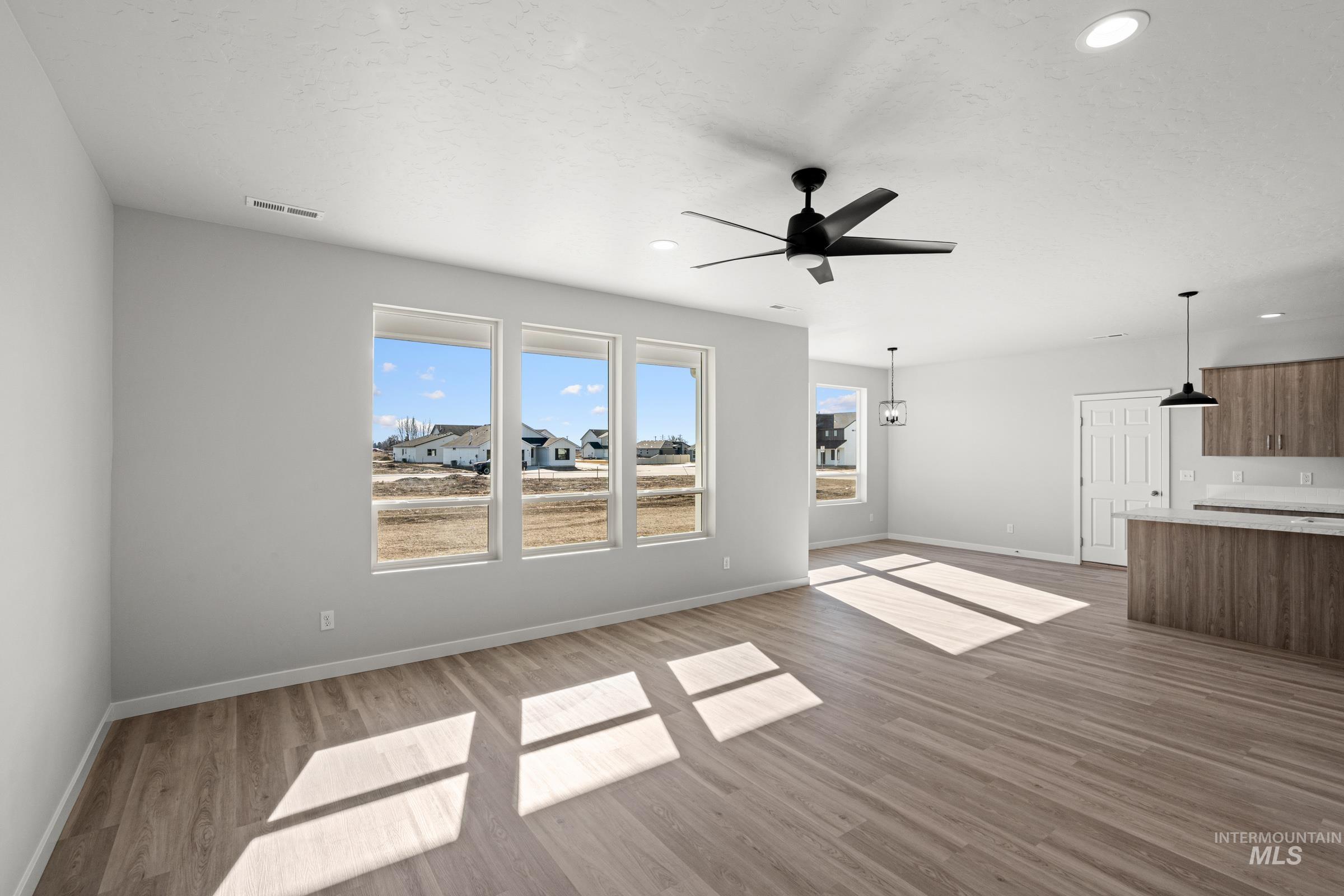 1641 Dyer Street Middleton, ID 83644 - Photo 9 of 28 Unfurnished living room featuring ceiling fan, light wood finished floors, and recessed lighting