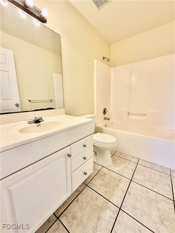 4739 28th Street Southwest Lehigh Acres, FL 33973 - Photo 16 of 16 a bathroom with a sink a toilet and a mirror