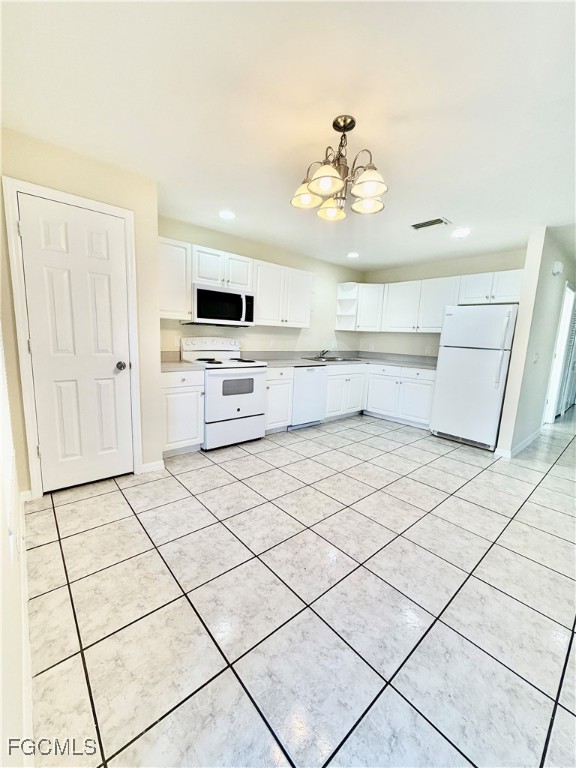 4739 28th Street Southwest Lehigh Acres, FL 33973 - Photo 5 of 16 a kitchen with stainless steel appliances kitchen island granite countertop a sink and cabinets