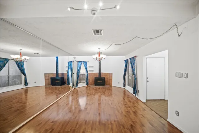 a view of a room with wooden floor