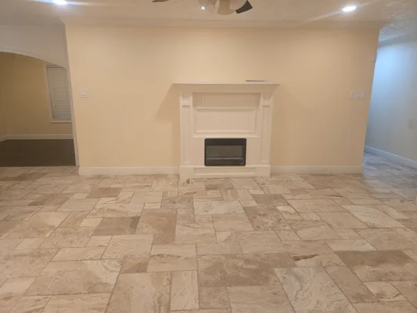a view of empty room with a fireplace