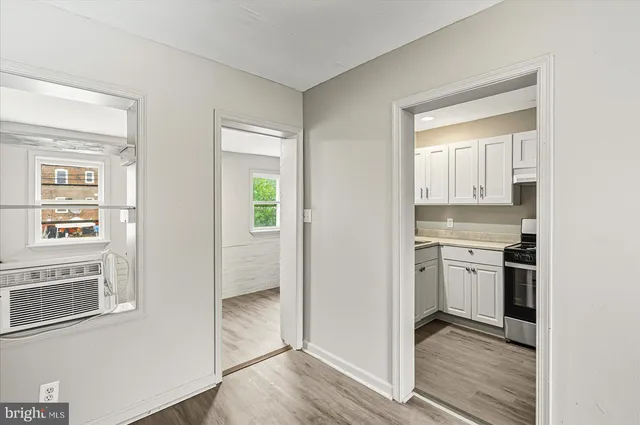 a kitchen with white cabinets and appliances