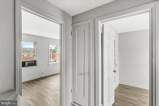 an empty room with wooden floor and a window