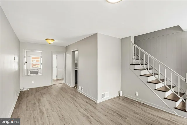 an empty room with windows and closet