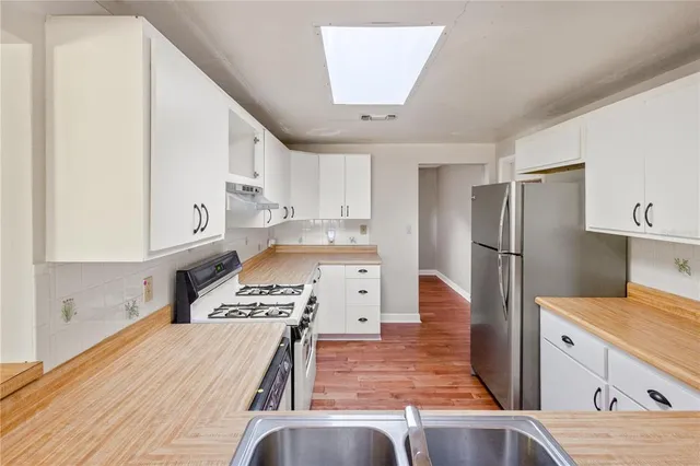 a kitchen with a refrigerator sink and stove