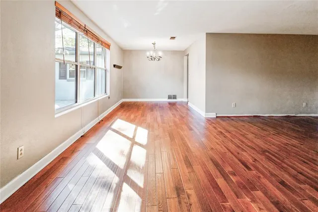 a view of an empty room and wooden floor