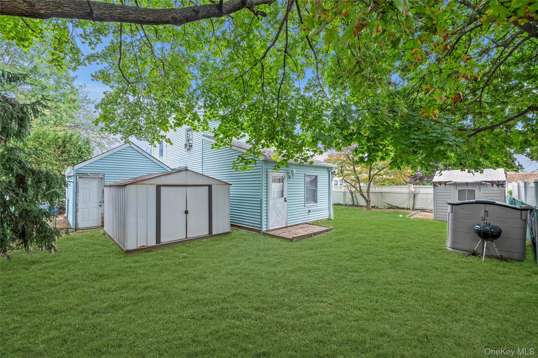 253 Raff Avenue Carle Place, NY 11514 - Photo 15 of 20 a view of backyard with green space