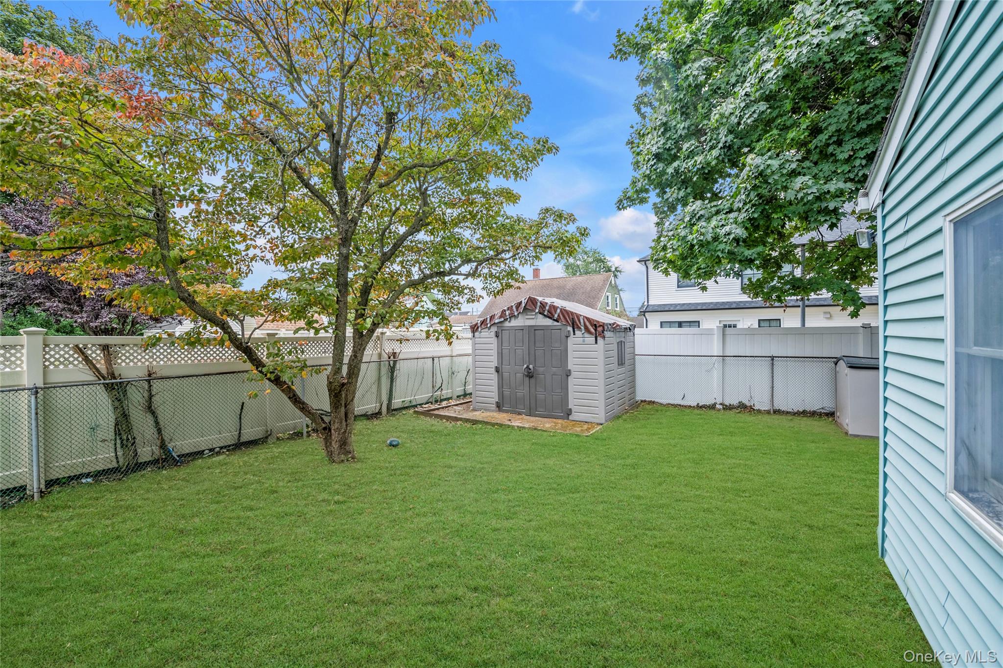 253 Raff Avenue Carle Place, NY 11514 - Photo 16 of 20 a view of a house with a yard