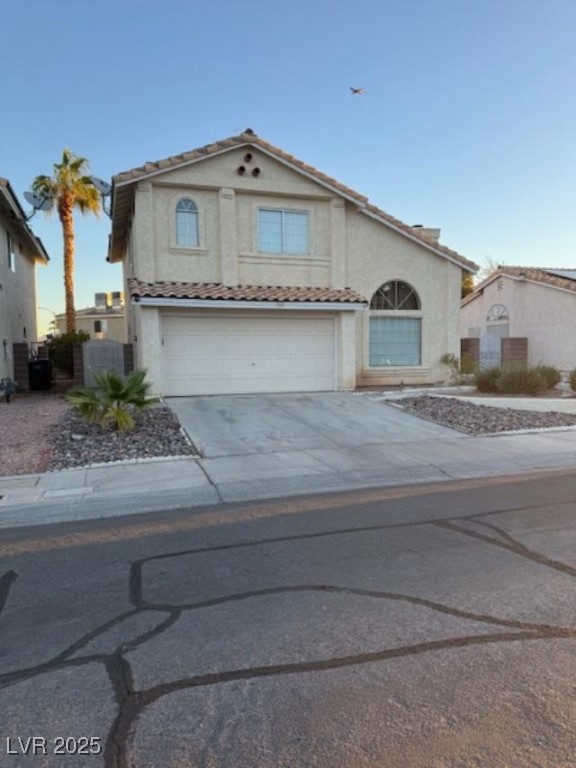 713 Rusty Spur Drive Henderson, NV 89014 - Photo 1 of 15 Mediterranean / spanish house with driveway, stucco siding, an attached garage, a tiled roof, and a gate