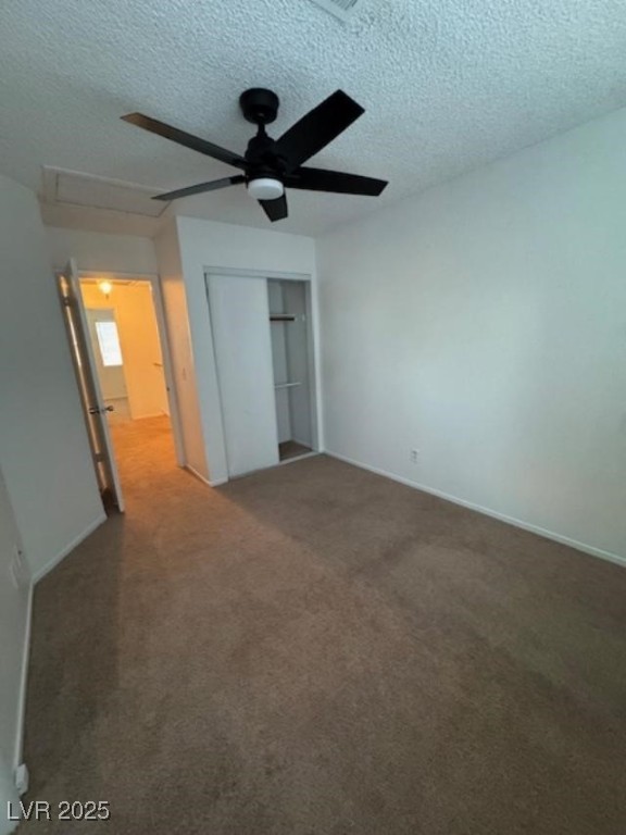 713 Rusty Spur Drive Henderson, NV 89014 - Photo 10 of 15 Unfurnished bedroom with a textured ceiling, dark colored carpet, a ceiling fan, and a closet