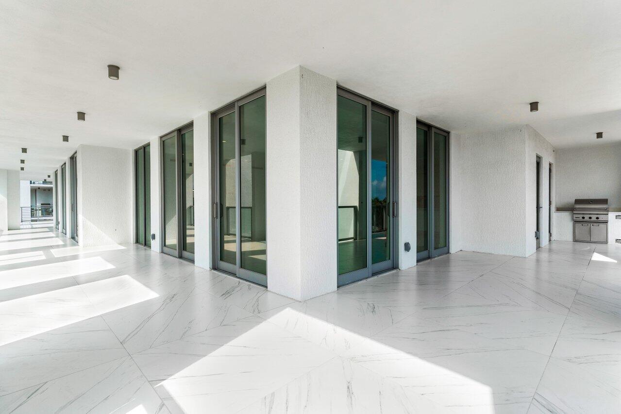 495 East Royal Palm Road, Unit 402 Boca Raton, FL 33432 - Photo 44 of 72 a view of a hallway with wooden floor and a living room