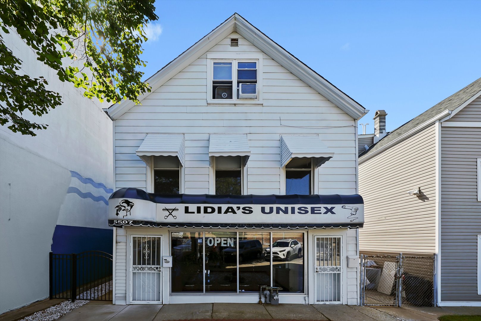 a view of a house with large windows and a small yard