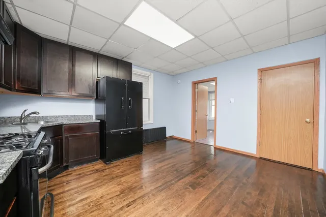a kitchen with a refrigerator stove and wooden cabinets