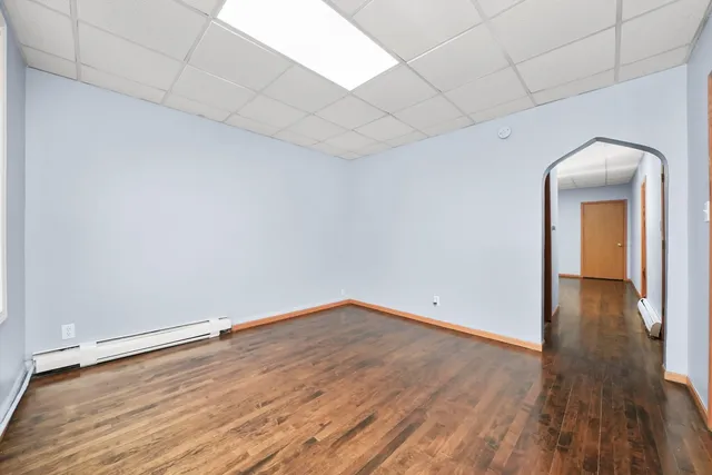 a view of a room with wooden floor