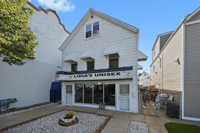 a front view of a house with a garden