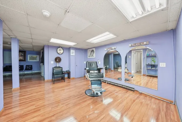 a view of a living room and kitchen with furniture wooden floor and window