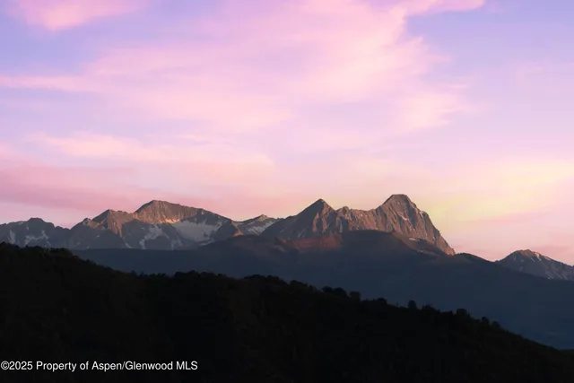 a view of a city with sunset in background
