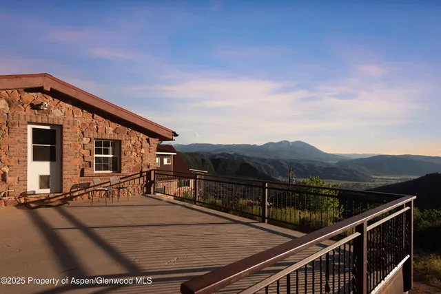 a view of a house with a wooden fence