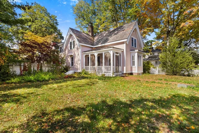 a front view of house with yard and trees around