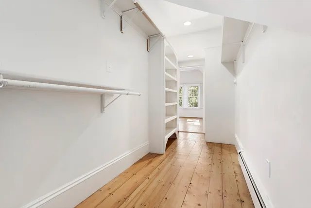 a view of hallway with wooden floor