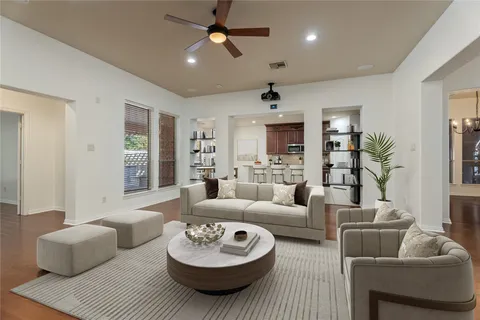 a living room with furniture and a wooden floor