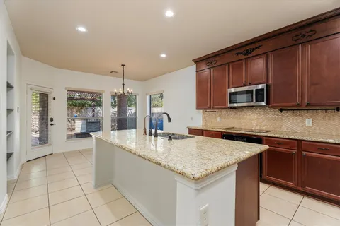 a kitchen with stainless steel appliances granite countertop a sink and cabinets