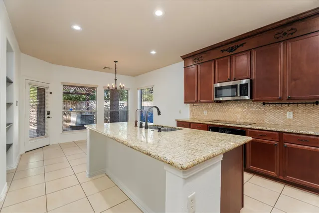 a kitchen with stainless steel appliances granite countertop a sink and cabinets