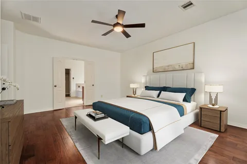 a bedroom with a bed and wooden floor