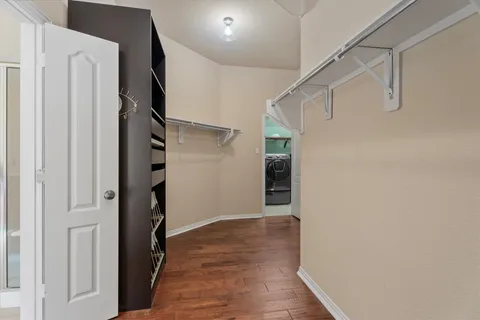 a view of hallway with stairs and wooden floor