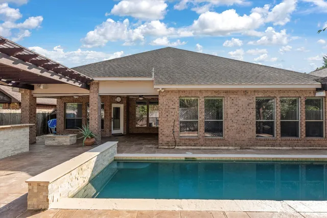 a swimming pool with outdoor seating