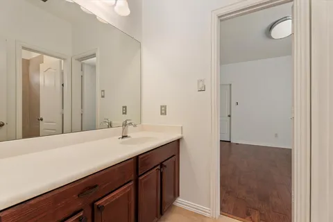 a bathroom with a sink a mirror and a vanity