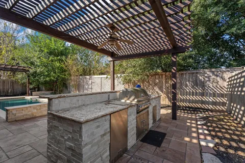 a view of outdoor kitchen with sitting area