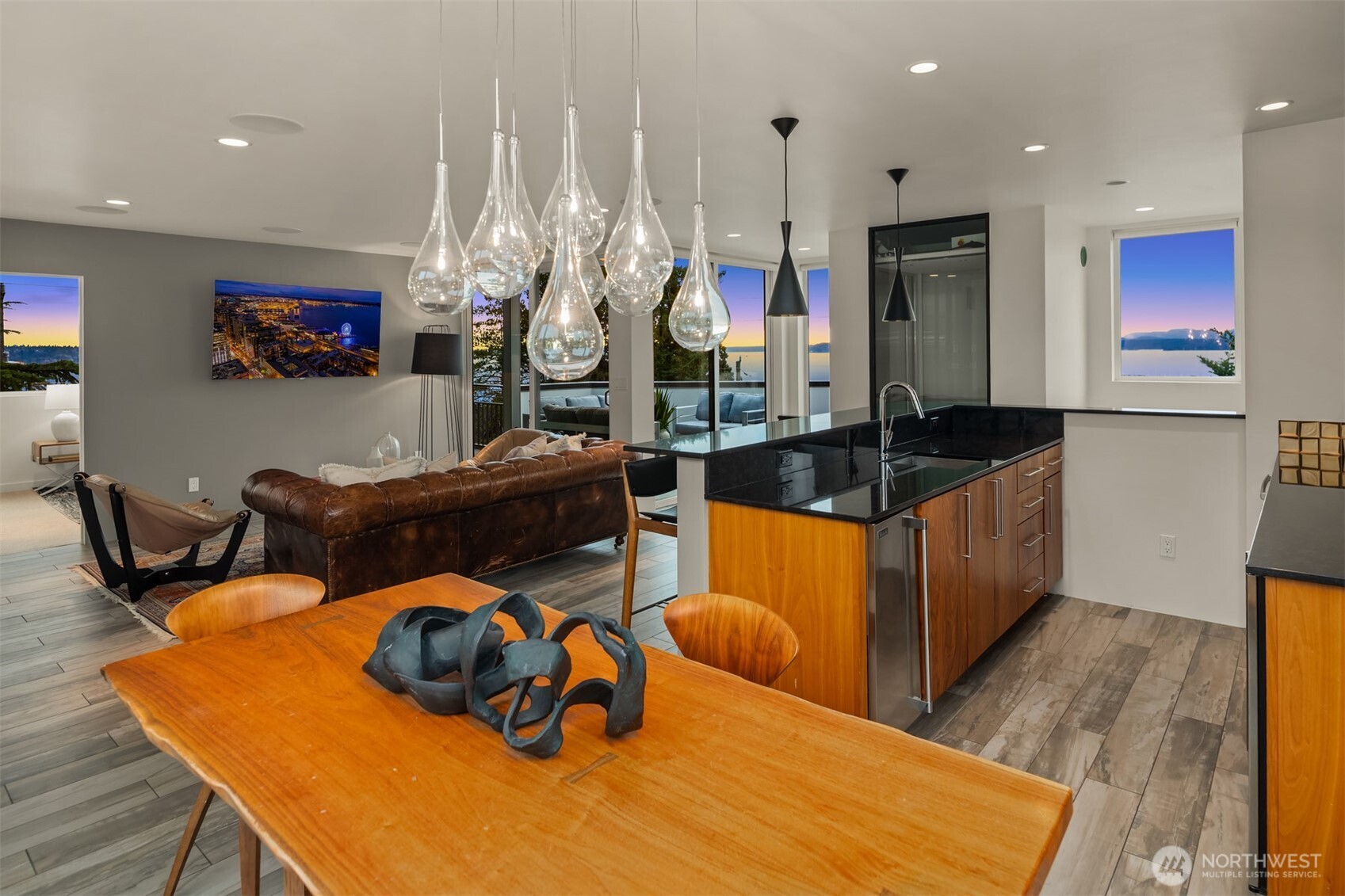 1400 Olympic Way West Seattle, WA 98119 - Photo 23 of 40 a kitchen with stainless steel appliances kitchen island granite countertop a table and chairs in it