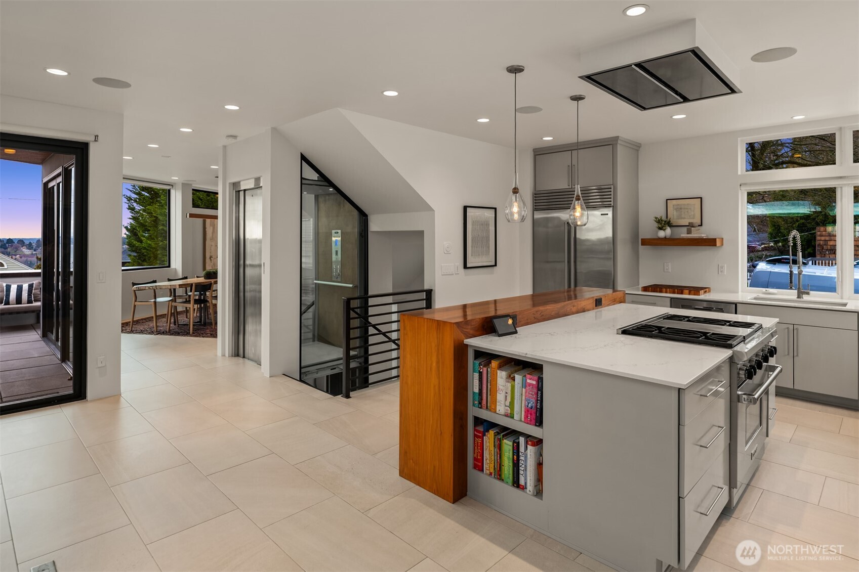 1400 Olympic Way West Seattle, WA 98119 - Photo 7 of 40 a kitchen that has a lot of cabinets in it and wooden floors
