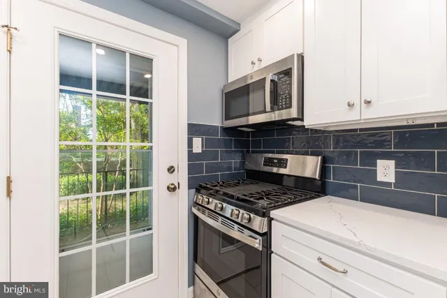 a kitchen with a stove microwave and sink