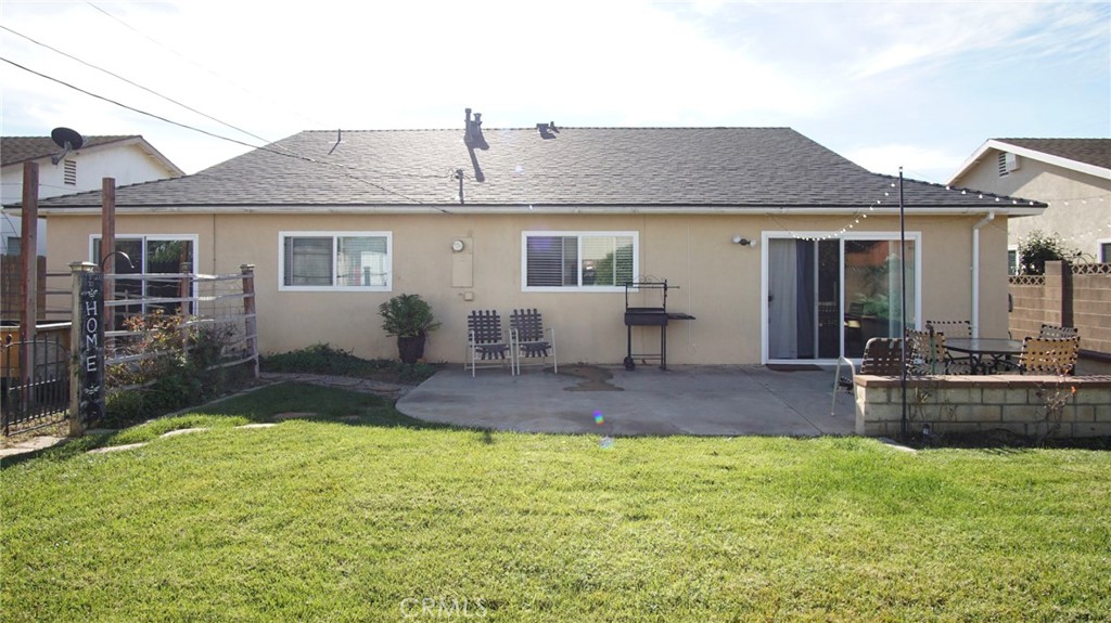911 East Evergreen Avenue Santa Maria, CA 93454 - Photo 18 of 48 a front view of house with yard outdoor seating and barbeque oven