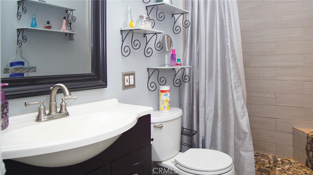 911 East Evergreen Avenue Santa Maria, CA 93454 - Photo 24 of 48 a bathroom with a sink a toilet and shower curtain