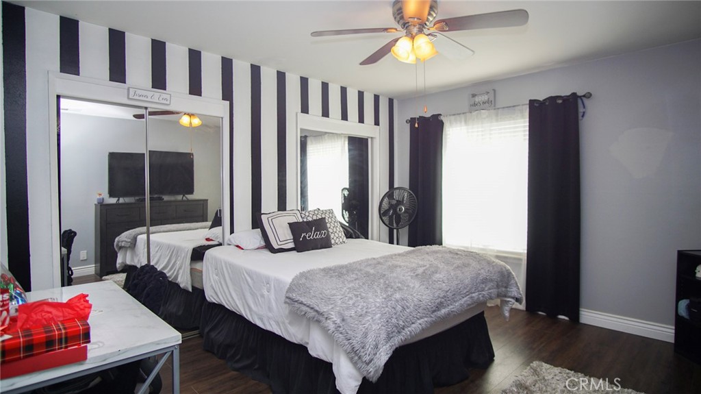 911 East Evergreen Avenue Santa Maria, CA 93454 - Photo 26 of 48 a bedroom with a bed a chandelier and closet