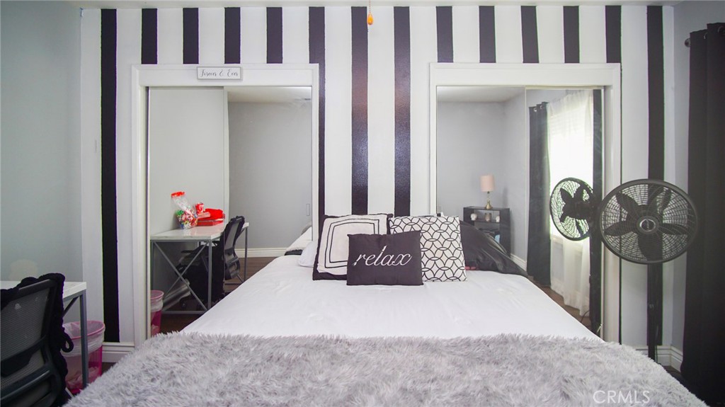 911 East Evergreen Avenue Santa Maria, CA 93454 - Photo 27 of 48 a bedroom with a bed and a mirror