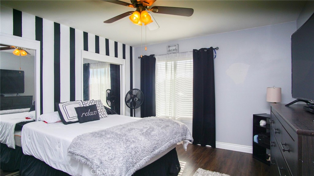 911 East Evergreen Avenue Santa Maria, CA 93454 - Photo 33 of 48 a bedroom with a bed and a chandelier